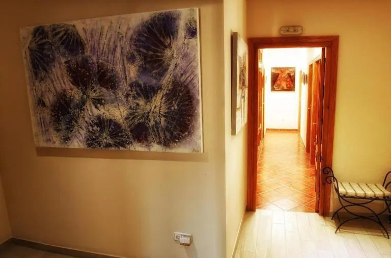 View of two paintings hanging in the room