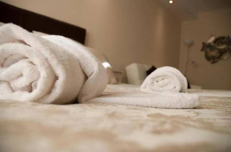 Towels rolled up on the bed